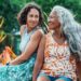 Caregiver image, older daughter and mother sitting out in nature together