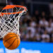 A basketball swishes through a hoop.