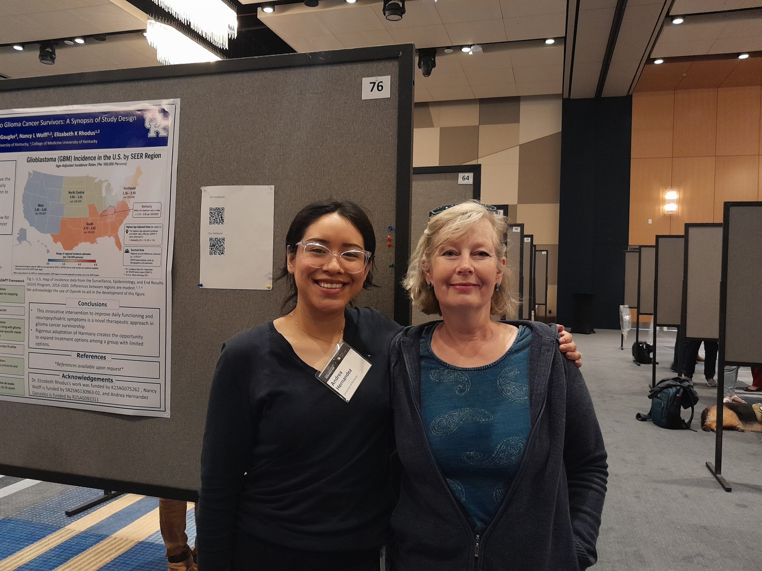 Andrea poses with one of her mentors beside research poster