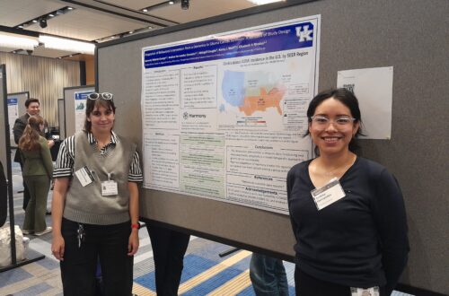 Kennedy and Andrea pose in front of poster at Markey Cancer Research Day