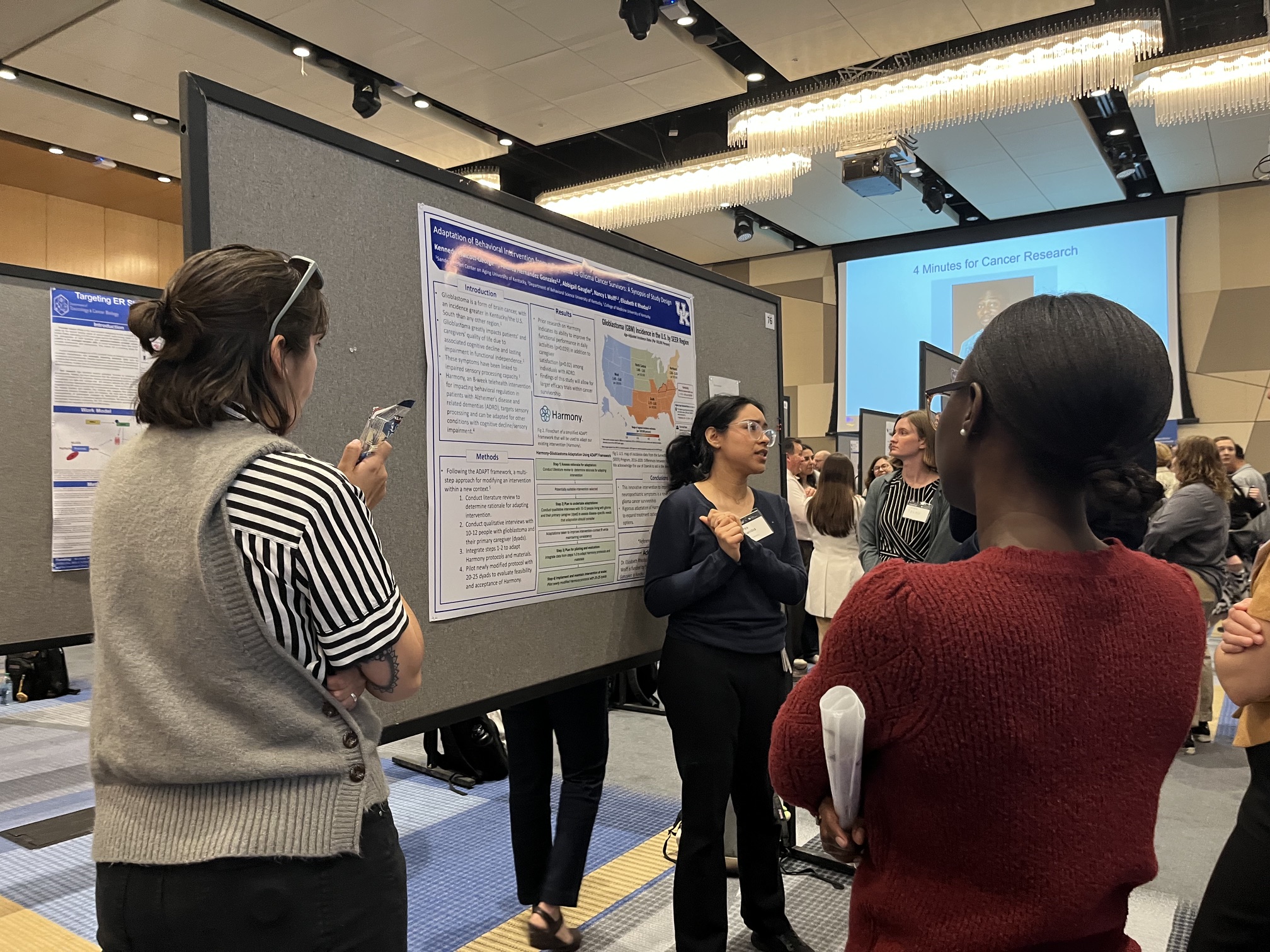 Andrea and Kennedy present research poster to conference attendees