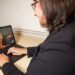 Dr. Elizabeth Rhodus delivering Harmony to an older woman through Telehealth